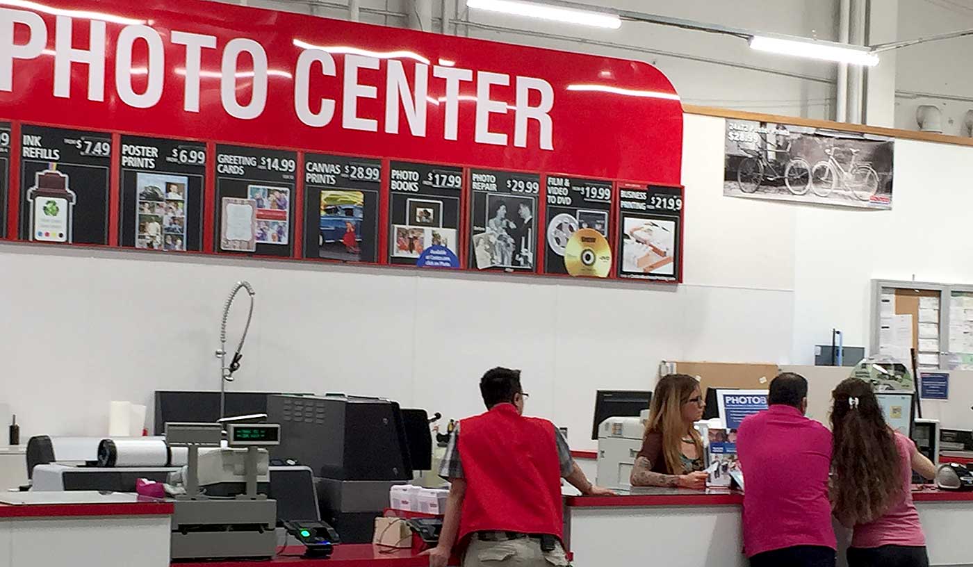 Costco employee helping customers in the Costco Photo Center